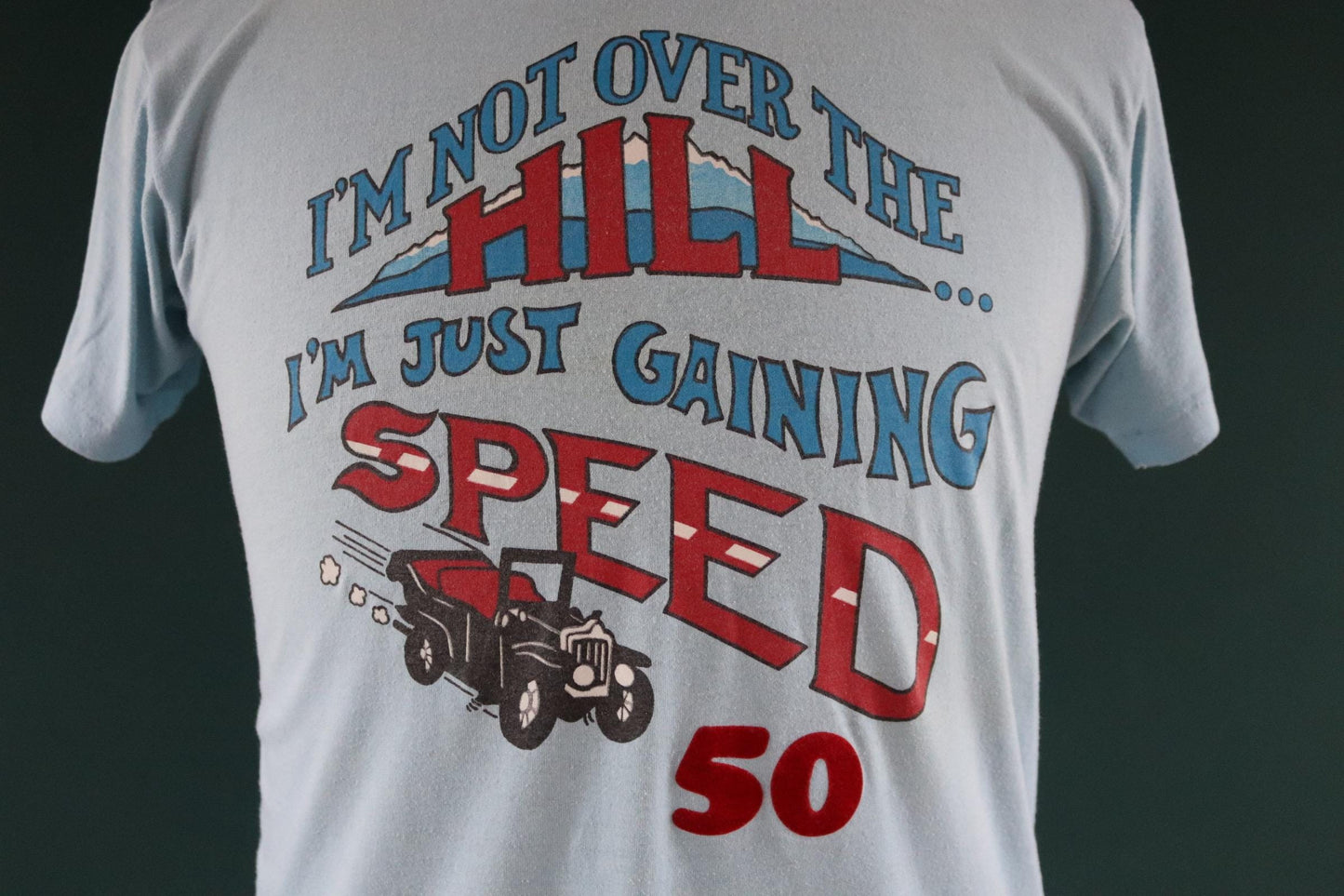 Vintage 1970s 70s 1980s 80s sky blue poly cotton 50th birthday souvenir Charlie over the hill sports sportswear t shirt 38” chest