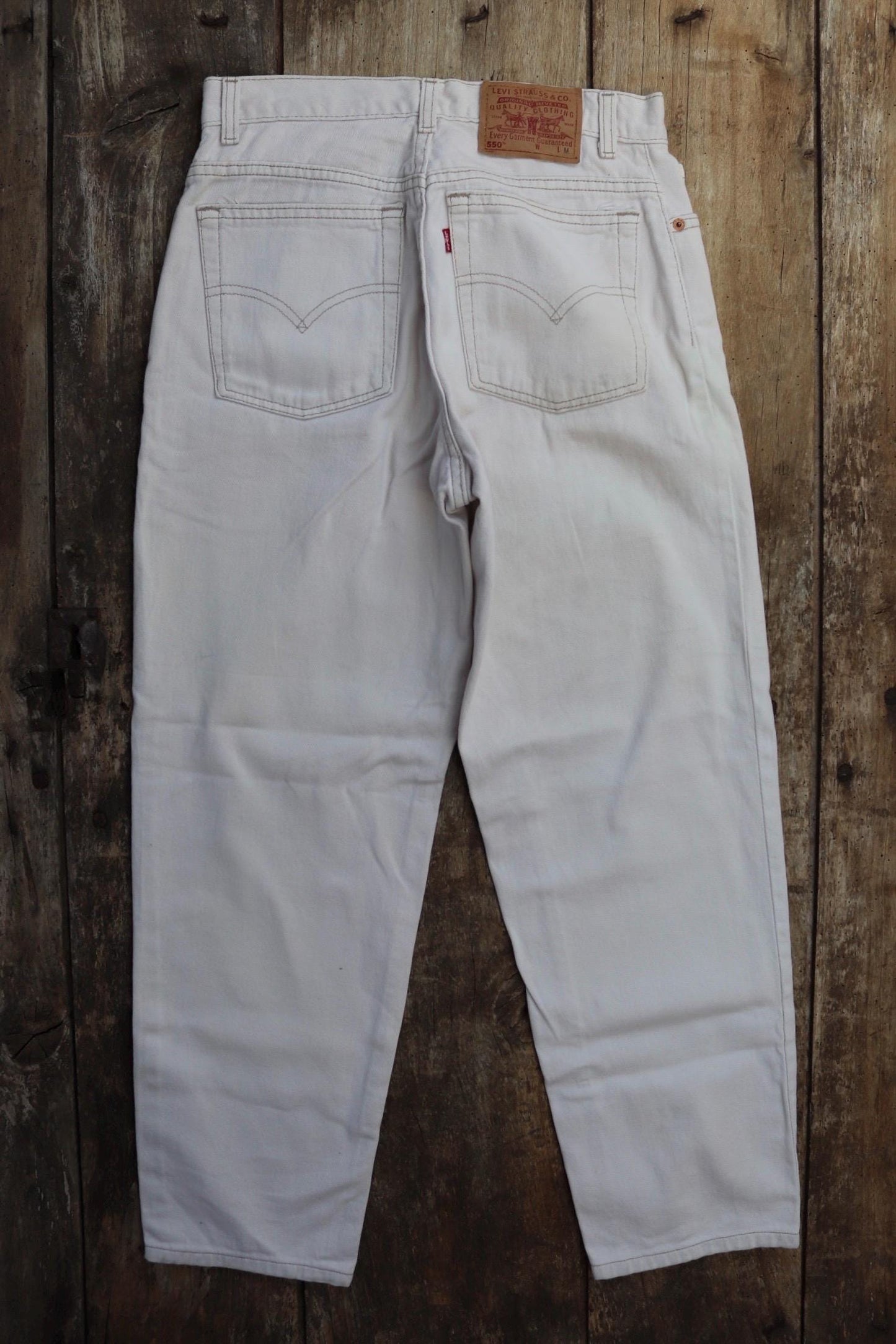 Vintage 1990s Levis 550 white denim jeans - Levi Strauss red tab - barrel leg - small e - zip fly - 29” x 38”