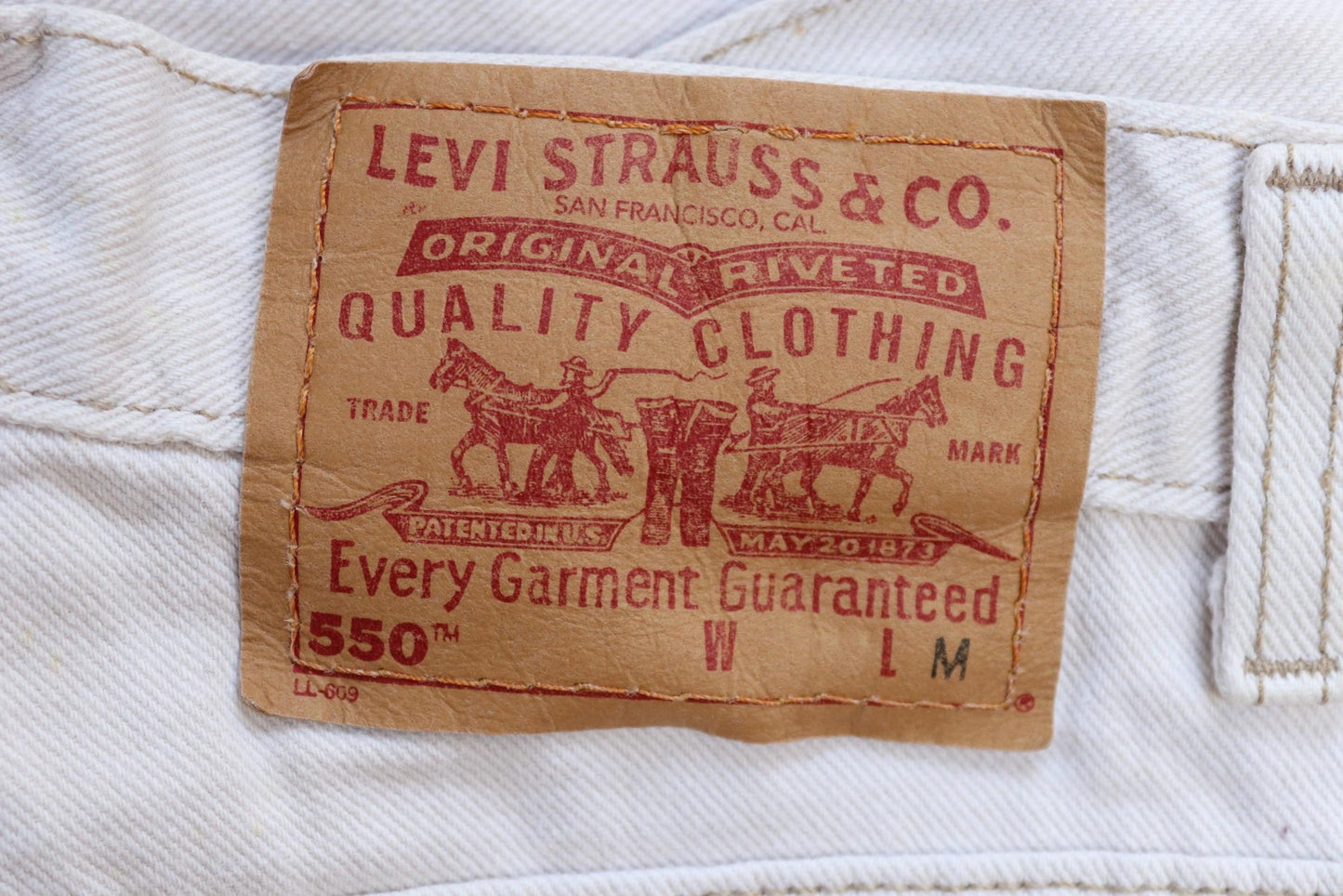 Vintage 1990s Levis 550 white denim jeans - Levi Strauss red tab - barrel leg - small e - zip fly - 29” x 38”