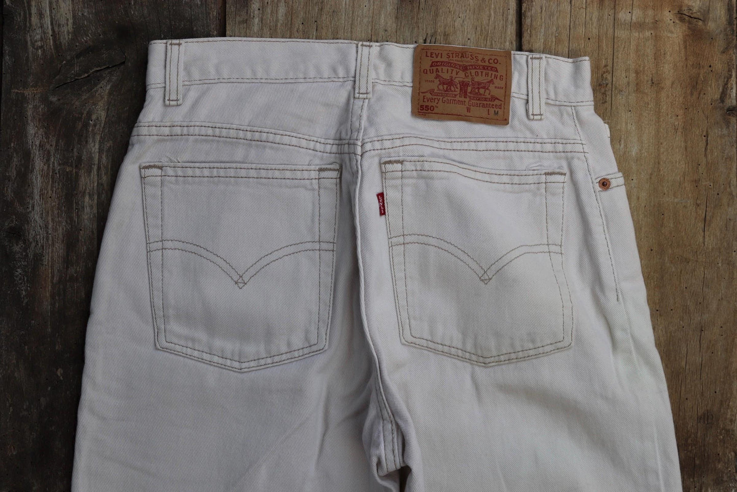 Vintage 1990s Levis 550 white denim jeans - Levi Strauss red tab - barrel leg - small e - zip fly - 29” x 38”