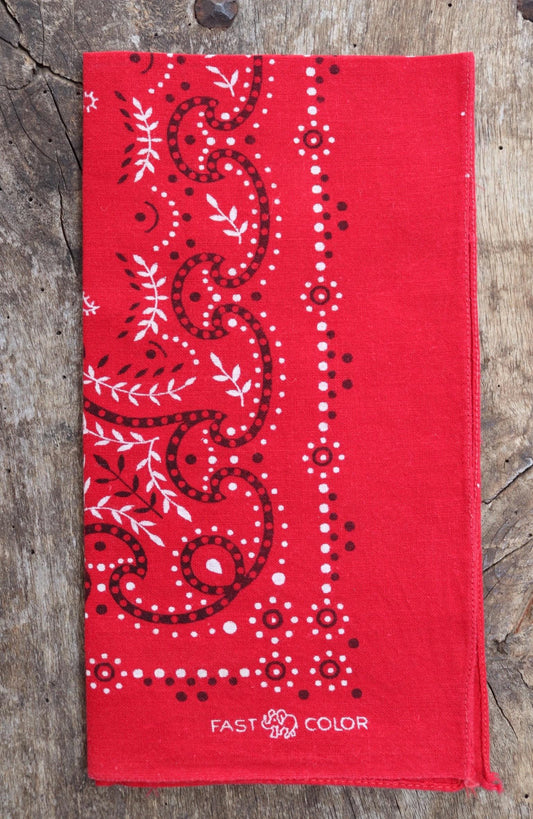 A vintage red cotton bandana by Davis and Catterall, dating from the 1960s