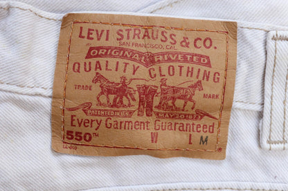 Vintage 1990s Levis 550 white denim jeans - Levi Strauss red tab - barrel leg - small e - zip fly - 29” x 38”